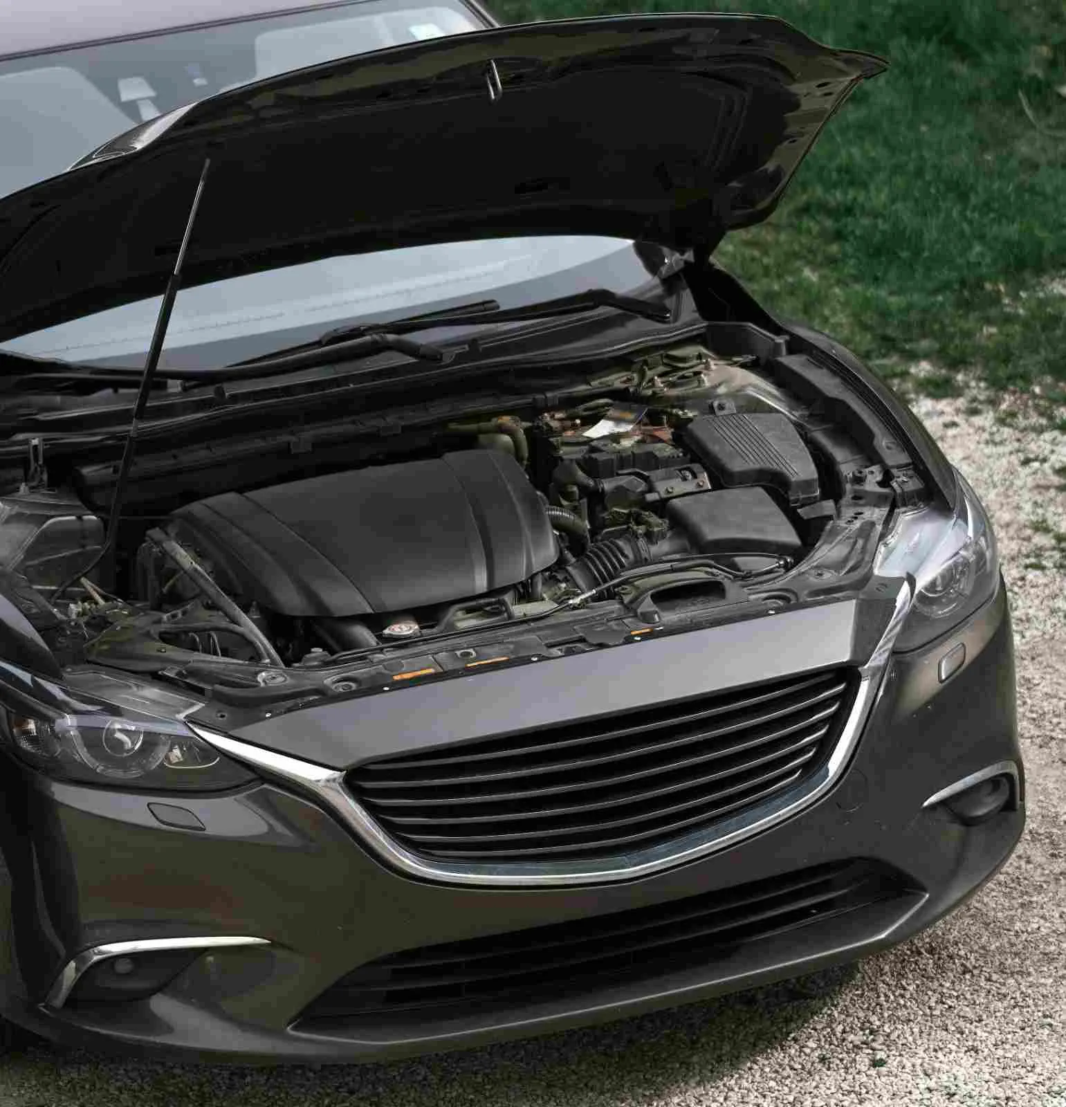 Dark sedan with its hood open showing the engine bay